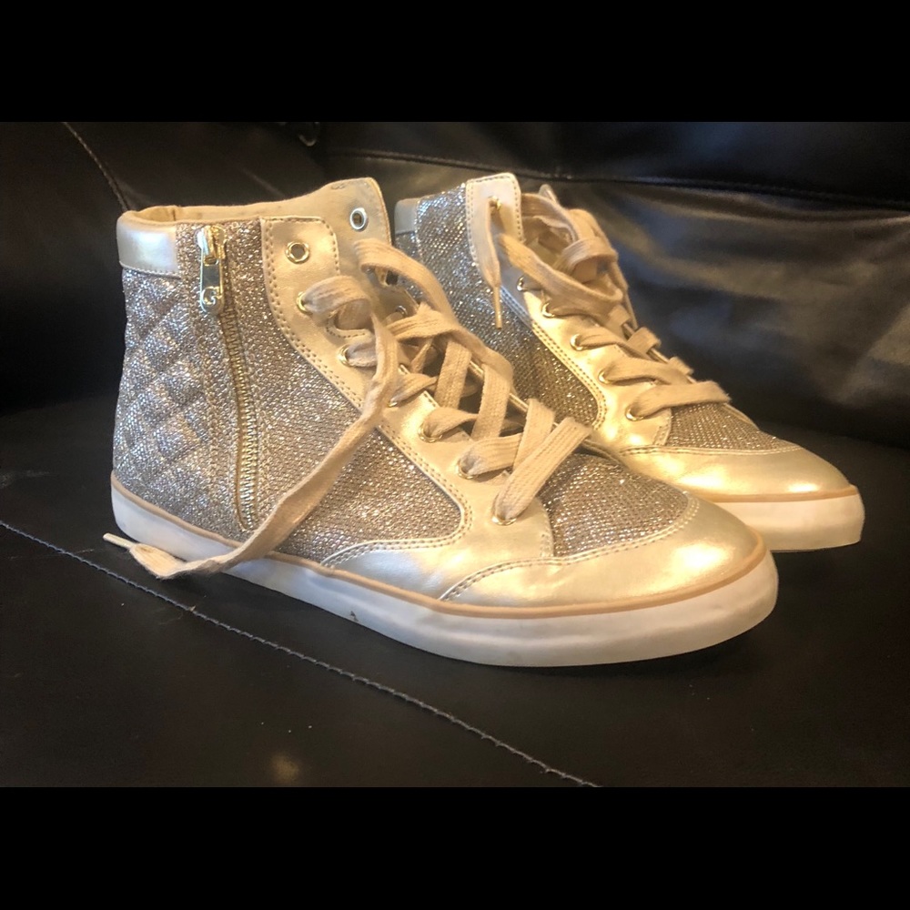 Gold Guess sneakers.